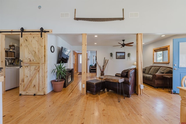 85 Mclain Ct, Pagosa Springs, CO 81147 - living room featuring visible vents, washer / dryer, and light wood finished floors
