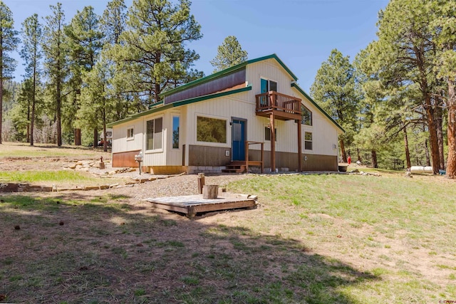 85 Mclain Ct, Pagosa Springs, CO 81147 - back of house featuring a lawn, entry steps, and a balcony