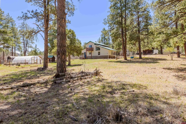 85 Mclain Ct, Pagosa Springs, CO 81147 - view of yard featuring an outbuilding and a greenhouse