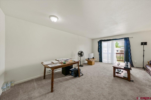 carpeted office featuring a textured ceiling and baseboards