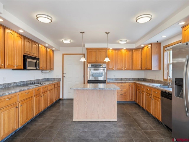 kitchen with brown cabinets, a sink, a center island, stainless steel appliances, and decorative light fixtures