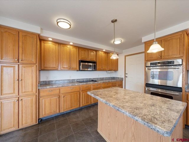 kitchen with a center island, light countertops, appliances with stainless steel finishes, and decorative light fixtures