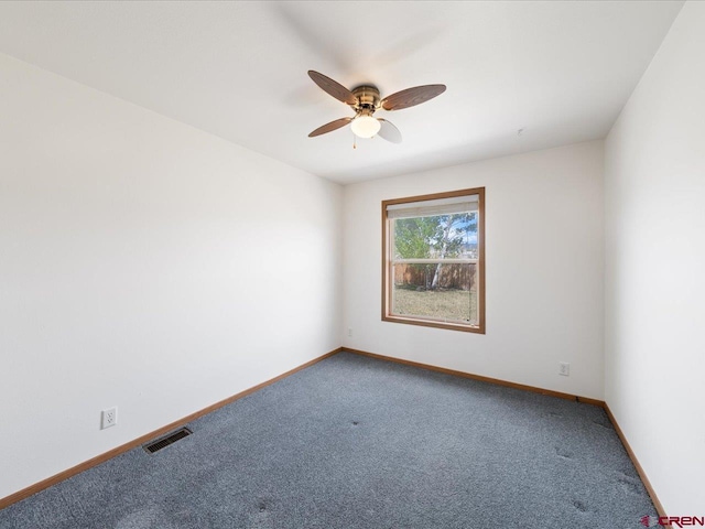 spare room featuring baseboards, ceiling fan, carpet flooring, and visible vents