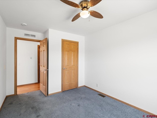 unfurnished bedroom with visible vents, carpet, and baseboards