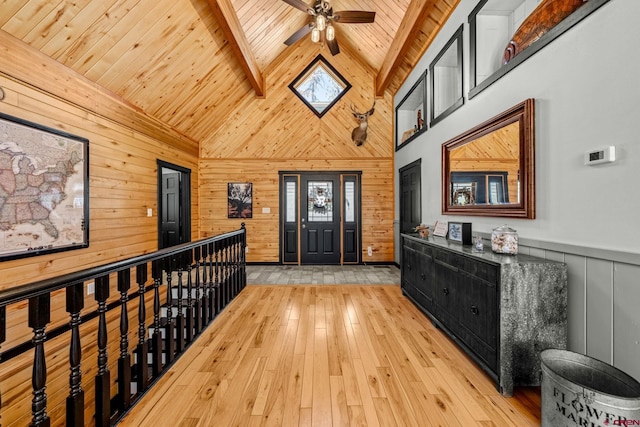 foyer with ceiling fan, beam ceiling, light wood finished floors, high vaulted ceiling, and wood ceiling