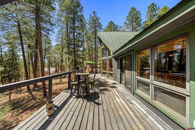 wooden deck featuring outdoor dining area