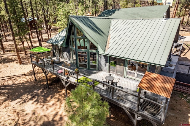 exterior space featuring metal roof and a deck