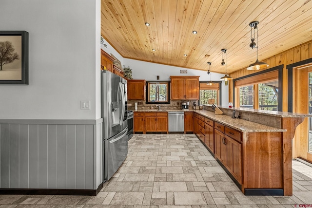kitchen with brown cabinetry, appliances with stainless steel finishes, a sink, wooden ceiling, and a peninsula