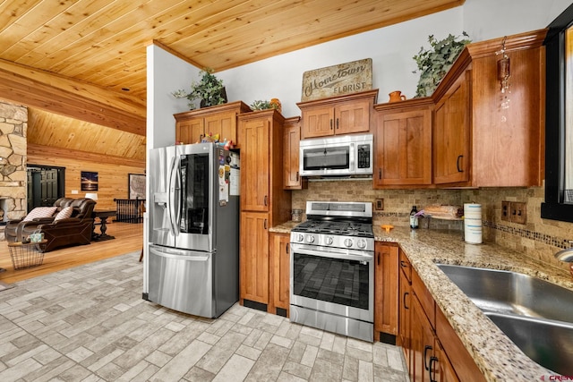 kitchen featuring brown cabinets, wooden ceiling, tasteful backsplash, a sink, and stainless steel appliances