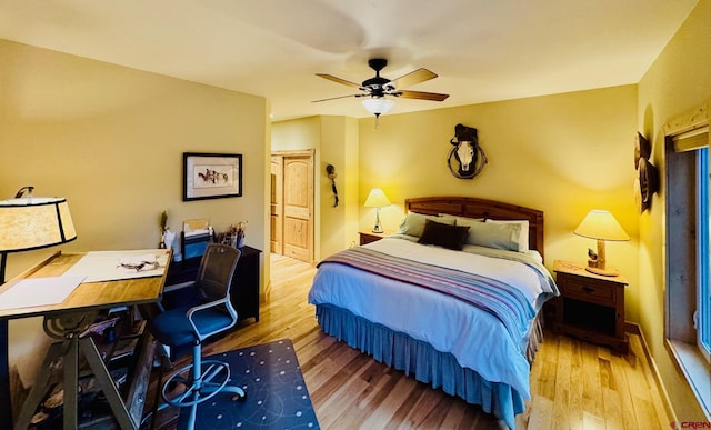 bedroom with a closet, a ceiling fan, and wood finished floors