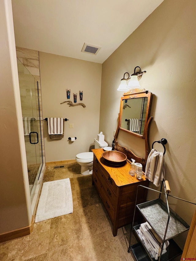 full bath featuring toilet, visible vents, a shower stall, and vanity