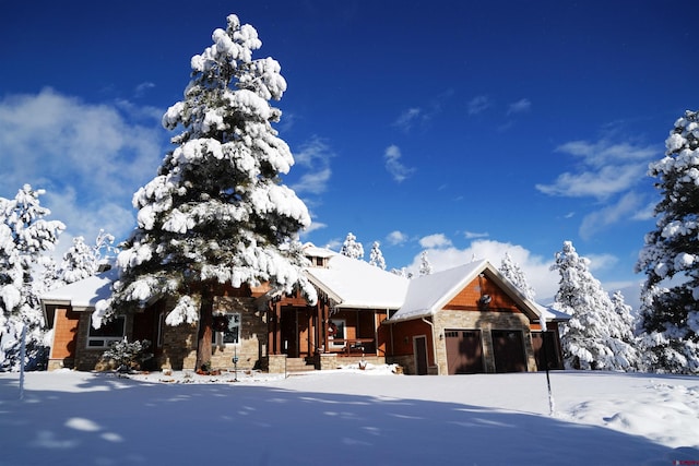rustic home featuring a garage, a porch, and stone siding
