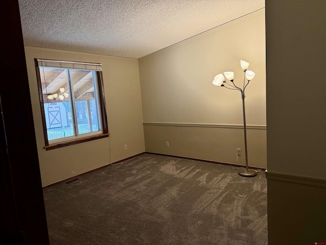 carpeted spare room featuring a textured ceiling