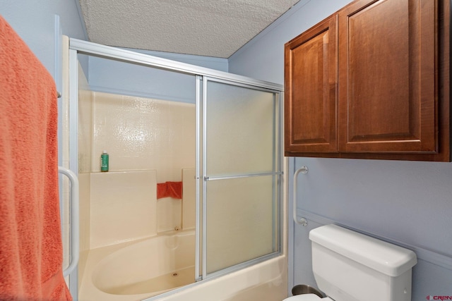 full bathroom with bath / shower combo with glass door, toilet, and a textured ceiling