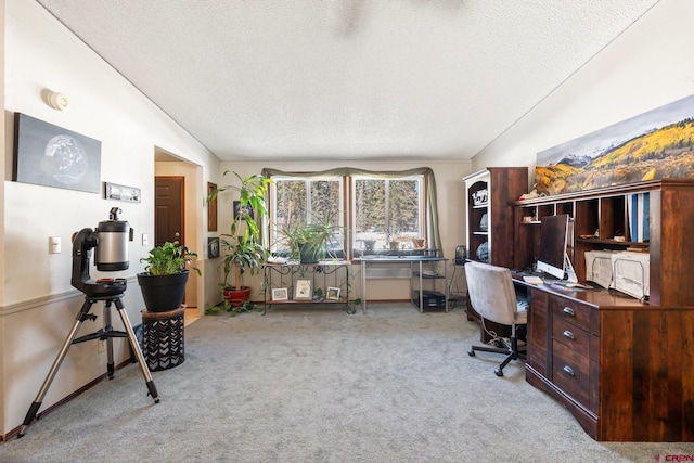 office with vaulted ceiling, baseboards, carpet flooring, and a textured ceiling