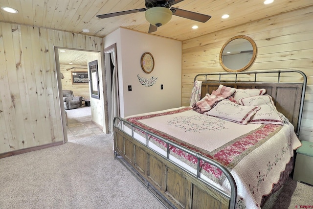 bedroom with wooden walls, wooden ceiling, recessed lighting, and light colored carpet