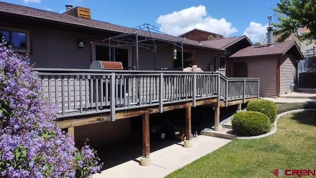 back of property featuring a wooden deck and a chimney