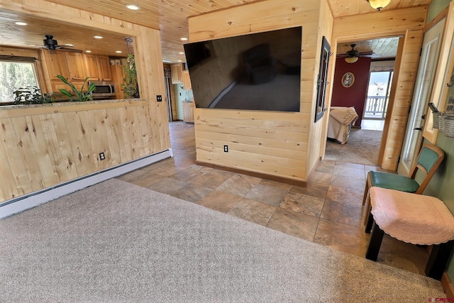living room featuring a ceiling fan, recessed lighting, a baseboard heating unit, and stone tile floors