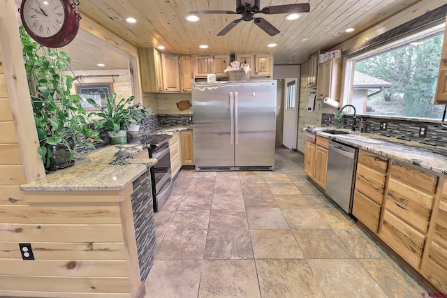 kitchen with light brown cabinetry, ceiling fan, recessed lighting, a sink, and appliances with stainless steel finishes