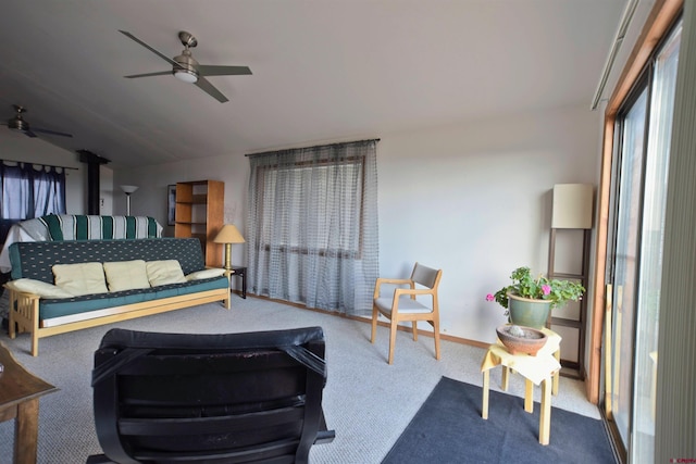 carpeted living room featuring baseboards, ceiling fan, and vaulted ceiling