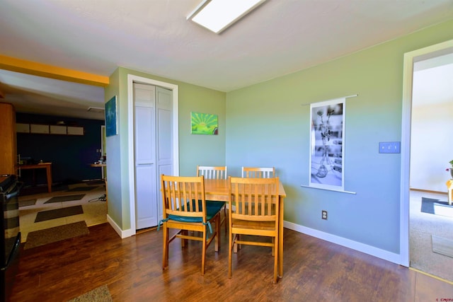 dining space featuring baseboards and wood finished floors