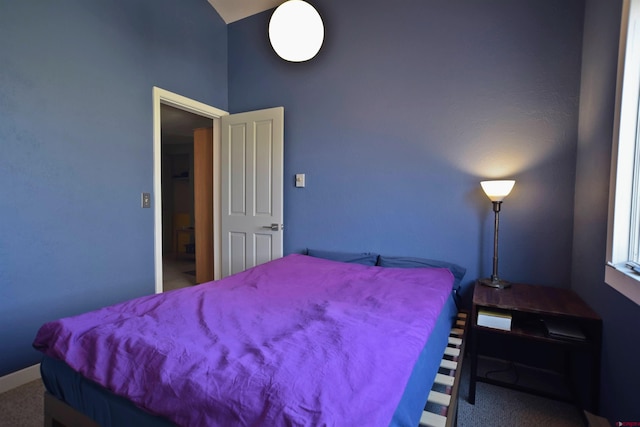 bedroom featuring carpet flooring, high vaulted ceiling, and baseboards