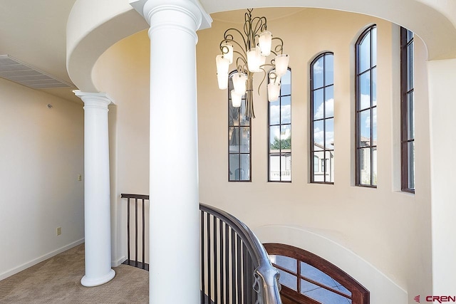 interior space featuring a notable chandelier, carpet flooring, and visible vents