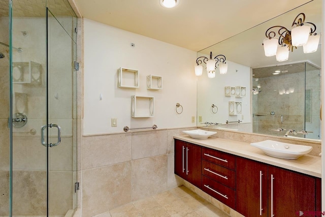full bathroom with tile walls, a sink, and a stall shower