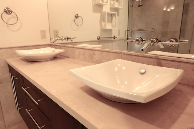 full bathroom with vanity, tile walls, wainscoting, and a shower