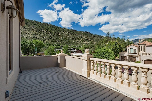 wooden deck with a mountain view