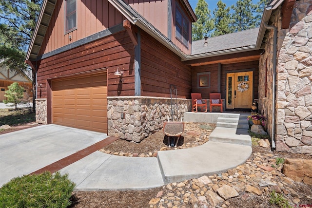 300 Copper Rim Trl, Durango, CO 81301 - doorway to property featuring covered porch, board and batten siding, stone siding, and a garage
