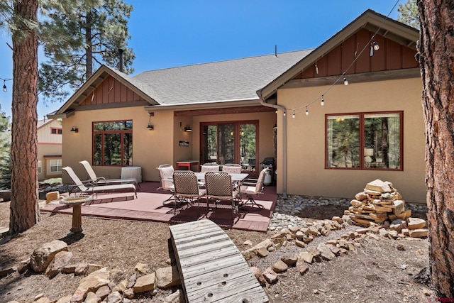 300 Copper Rim Trl, Durango, CO 81301 - rear view of house featuring stucco siding, board and batten siding, a patio area, and roof with shingles