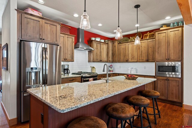 300 Copper Rim Trl, Durango, CO 81301 - kitchen featuring wall chimney range hood, backsplash, stainless steel appliances, and dark wood finished floors