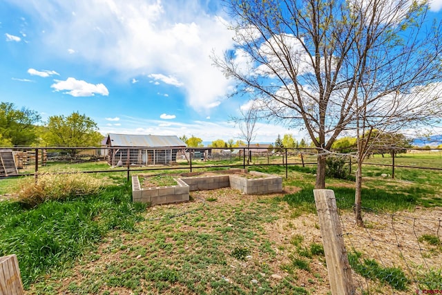 view of yard with fence and a garden