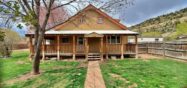 108 N 15th St, Dolores, CO 81323 - view of front of house featuring a fenced backyard, a mountain view, and a front yard