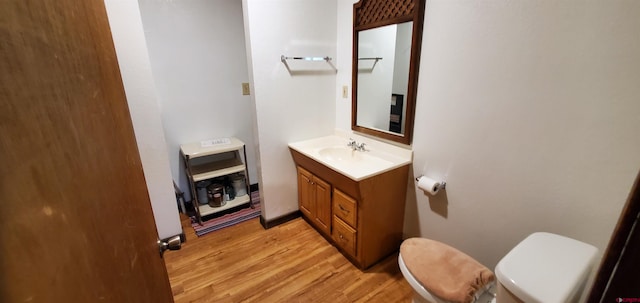 108 N 15th St, Dolores, CO 81323 - bathroom featuring vanity, wood finished floors, and toilet
