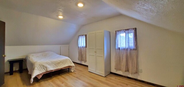 108 N 15th St, Dolores, CO 81323 - bedroom with baseboards, light wood-style flooring, and lofted ceiling