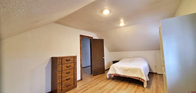 108 N 15th St, Dolores, CO 81323 - bedroom with a textured ceiling, vaulted ceiling, and wood finished floors