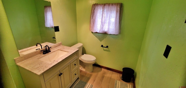 108 N 15th St, Dolores, CO 81323 - half bath with vanity, baseboards, toilet, and wood finished floors