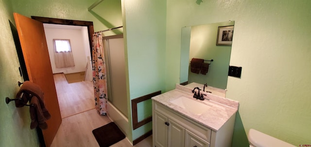 108 N 15th St, Dolores, CO 81323 - bathroom featuring vanity, shower / tub combo, wood finished floors, and toilet