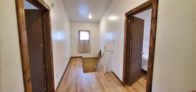 108 N 15th St, Dolores, CO 81323 - hall with light wood-style floors and an upstairs landing