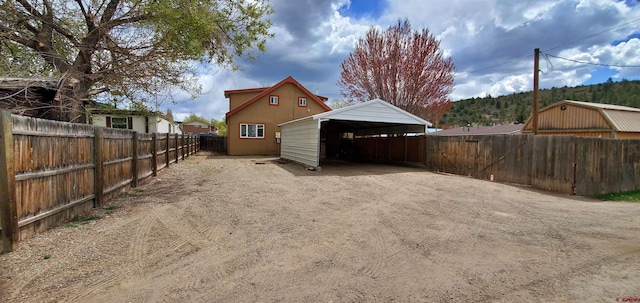 108 N 15th St, Dolores, CO 81323 - exterior space with dirt driveway, a detached carport, and fence