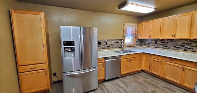 108 N 15th St, Dolores, CO 81323 - kitchen with a sink, light wood-style floors, light countertops, stainless steel appliances, and tasteful backsplash