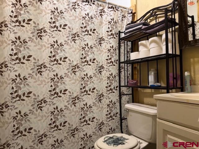 bathroom featuring toilet and vanity