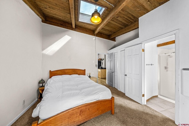 bedroom with lofted ceiling with beams, carpet, two closets, baseboards, and wooden ceiling