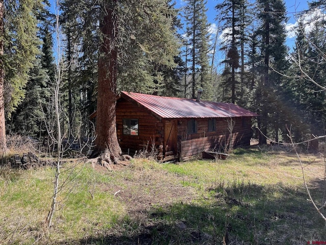 114 Meadowbrook Park, Creede, CO 81130 - view of outdoor structure featuring an outbuilding and a wooded view