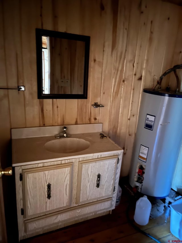 114 Meadowbrook Park, Creede, CO 81130 - bathroom featuring wood walls, water heater, and vanity