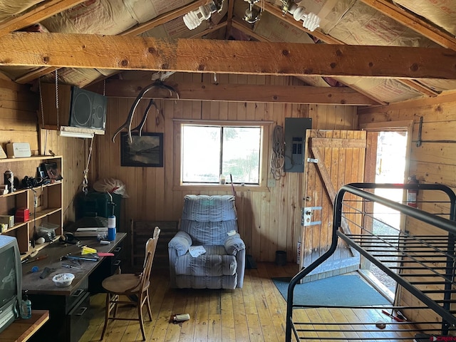 114 Meadowbrook Park, Creede, CO 81130 - bedroom featuring wood walls, multiple windows, electric panel, and light wood finished floors