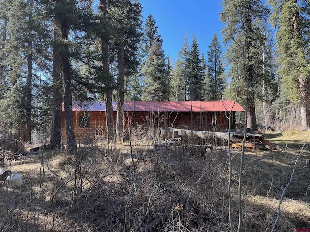 114 Meadowbrook Park, Creede, CO 81130 - view of home's exterior with a wooded view and metal roof