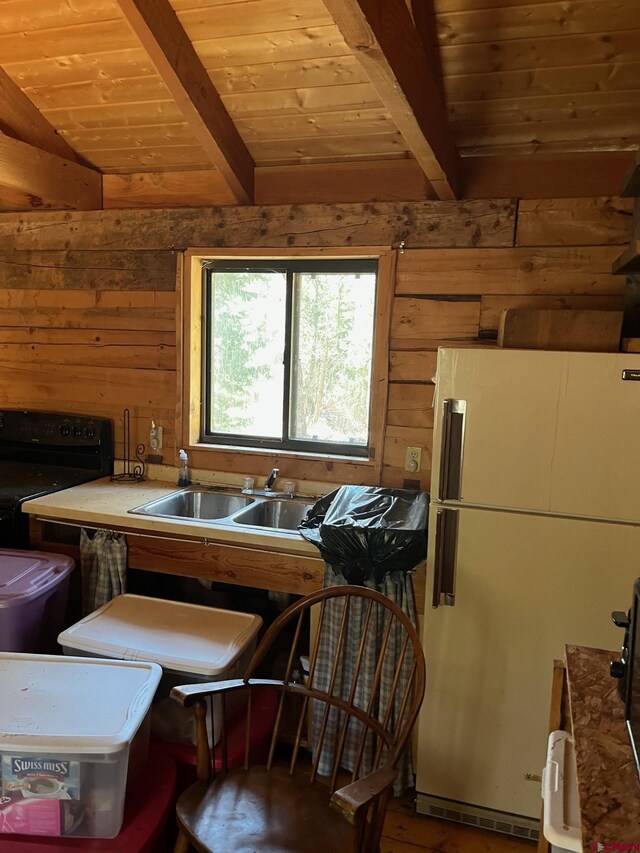 114 Meadowbrook Park, Creede, CO 81130 - interior space featuring wood ceiling, freestanding refrigerator, wood walls, and beam ceiling